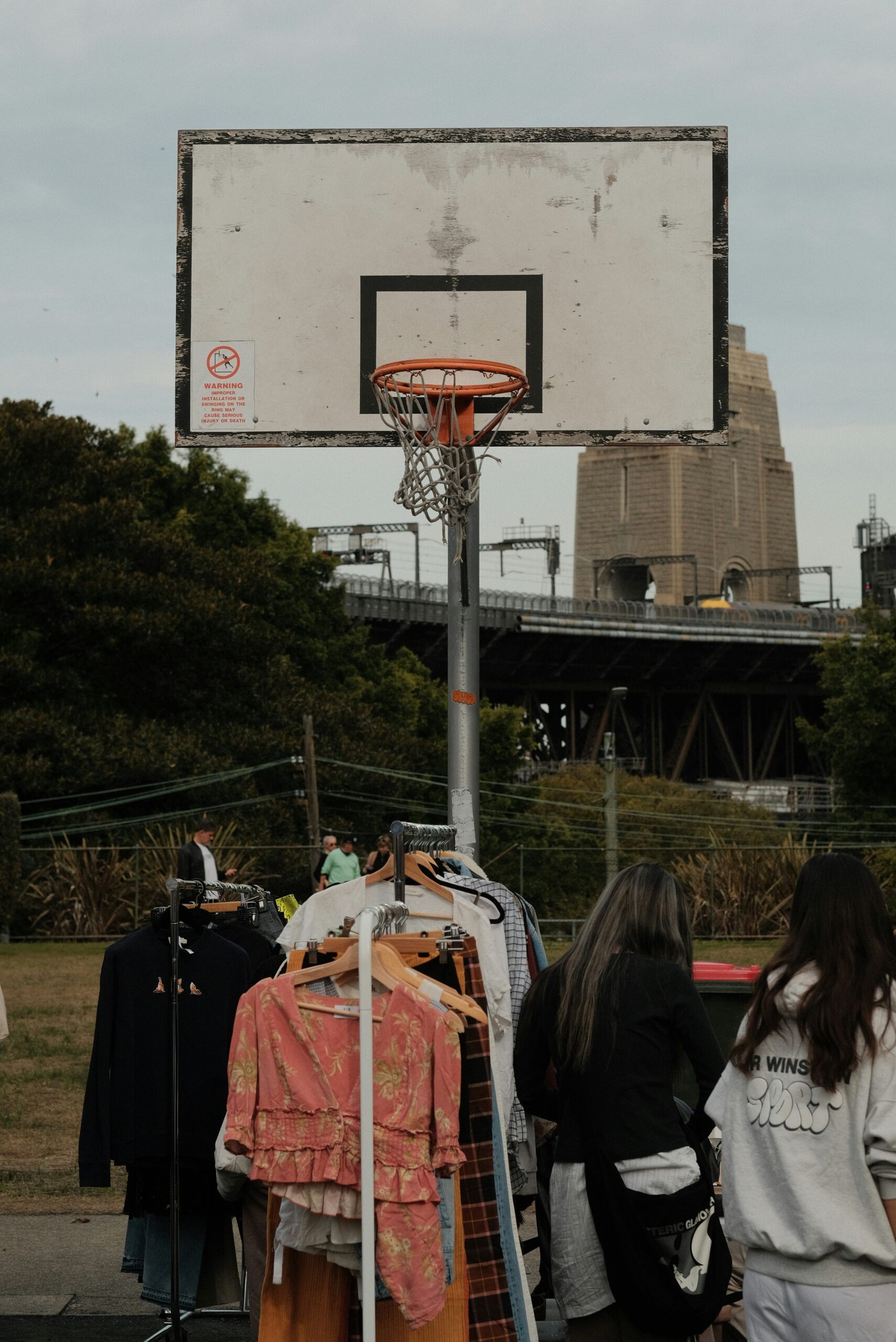 A group of people standing next to a basketball hoop